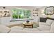 Cozy living room with a built-in window seat, storage cabinets, and a decorative mirror at 1235 Nelson St, Dunedin, FL 34698
