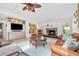 Cozy living room with a fireplace, large windows, a TV, and comfortable leather seating at 1235 Nelson St, Dunedin, FL 34698