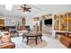 Open-concept living room with a fireplace and seamless connection to the adjacent kitchen at 1235 Nelson St, Dunedin, FL 34698