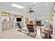 Bright living room with fireplace, tiled floors, stylish furnishings, and a ceiling fan at 1235 Nelson St, Dunedin, FL 34698