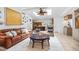 Spacious living room with natural light, comfortable leather seating, and seamless access to the kitchen at 1235 Nelson St, Dunedin, FL 34698