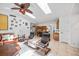 Open living space with skylights, a ceiling fan, tile floors, and a view into the eat-in kitchen at 1235 Nelson St, Dunedin, FL 34698