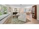 Bright living room features stylish seating, large windows, and views into the dining area at 1235 Nelson St, Dunedin, FL 34698