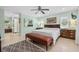 Airy bedroom with tiled floors, large bed, and ceiling fan at 1235 Nelson St, Dunedin, FL 34698