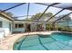 The outdoor living space offers a screened-in pool, bar, and lounging options to enjoy the sunshine at 1235 Nelson St, Dunedin, FL 34698