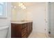 Bathroom featuring a dark wood vanity with light countertop and a bright shower at 1247 Overcash Dr, Dunedin, FL 34698
