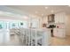 Modern kitchen with white cabinetry, a large island with seating, and stainless-steel appliances at 1247 Overcash Dr, Dunedin, FL 34698