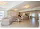 Spacious, bright living room with tile flooring and ample seating flowing into a well-equipped kitchen at 1247 Overcash Dr, Dunedin, FL 34698