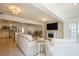 Open-concept living area with modern fireplace, and seamless transition to the kitchen with stainless appliances at 1247 Overcash Dr, Dunedin, FL 34698