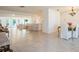 Open-concept living room with light tile flooring, a dining area, and an expansive seating area at 1247 Overcash Dr, Dunedin, FL 34698