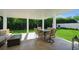 Inviting covered patio with comfortable seating, dining area, and lush green views, perfect for relaxation and entertaining at 1247 Overcash Dr, Dunedin, FL 34698