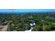 Aerial view of a home near Fred Howard Park, surrounded by lush greenery and the Gulf's blue waters at 1330 Belcher Dr, Tarpon Springs, FL 34689