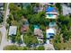 Aerial view of a charming neighborhood with lush greenery and mature trees, showcasing the home and its surroundings at 1330 Belcher Dr, Tarpon Springs, FL 34689