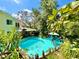 Aerial view of backyard pool with lush vegetation and seating area at 1330 Belcher Dr, Tarpon Springs, FL 34689