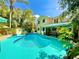 Beautiful backyard featuring a pool, lush greenery, and patio offering a serene outdoor space at 1330 Belcher Dr, Tarpon Springs, FL 34689