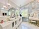 Bright bathroom with double sink vanity, elegant fixtures and a decorative make up vanity at 1330 Belcher Dr, Tarpon Springs, FL 34689