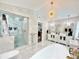 Elegant bathroom featuring marble floors and walls, dual sink vanity and glass enclosed shower at 1330 Belcher Dr, Tarpon Springs, FL 34689
