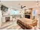 Bedroom boasts a fireplace, desk, TV, light gray wood-look flooring, and neutral colored walls at 1330 Belcher Dr, Tarpon Springs, FL 34689