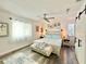This light-filled bedroom includes two windows and light gray wood-look flooring at 1330 Belcher Dr, Tarpon Springs, FL 34689