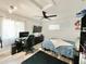 Bedroom features a desk, TV, ceiling fan, and light gray wood-look flooring at 1330 Belcher Dr, Tarpon Springs, FL 34689