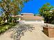 Inviting home featuring a three-car garage, charming landscaping, and a beautiful stairway entrance at 1330 Belcher Dr, Tarpon Springs, FL 34689