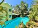 Aerial view of exterior highlighting a backyard with lush landscaping, a pool, and an outdoor seating area at 1330 Belcher Dr, Tarpon Springs, FL 34689