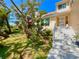 Charming home featuring a well-manicured lawn and a welcoming entrance, blending nature and curb appeal at 1330 Belcher Dr, Tarpon Springs, FL 34689