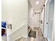 Bright hallway boasts wood-look floors, stairs, and neutral colored walls at 1330 Belcher Dr, Tarpon Springs, FL 34689