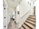 Bright hallway featuring hardwood floors and access to the bedroom and the staircase at 1330 Belcher Dr, Tarpon Springs, FL 34689
