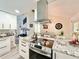 Kitchen with stainless steel appliances and granite countertops. The living room and dining room are also shown at 1330 Belcher Dr, Tarpon Springs, FL 34689