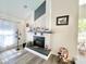 Bright living room featuring a stylish fireplace and decorative accents at 1330 Belcher Dr, Tarpon Springs, FL 34689