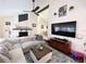Cozy living room with a fireplace, ceiling fan, and a mounted flat screen television at 1330 Belcher Dr, Tarpon Springs, FL 34689