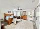 Spacious main bedroom with hardwood floors, decorative furniture, and ensuite bath access at 1330 Belcher Dr, Tarpon Springs, FL 34689