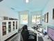 Bright home office with work space, large windows, and pool view at 1330 Belcher Dr, Tarpon Springs, FL 34689