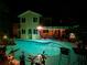 Backyard pool and patio illuminated at night, perfect for relaxation and outdoor entertaining at 1330 Belcher Dr, Tarpon Springs, FL 34689