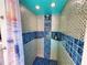 Outdoor pool shower features silver and blue mosaic tile at 1330 Belcher Dr, Tarpon Springs, FL 34689
