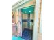 Outdoor pool shower features intricate mosaic tile work at 1330 Belcher Dr, Tarpon Springs, FL 34689