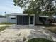 Back exterior with a screened in porch and patio at 13314 Lisa Dr, Hudson, FL 34667