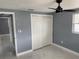 This cozy bedroom has a ceiling fan, double door closet, window, and tiled floor at 13314 Lisa Dr, Hudson, FL 34667