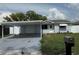 Charming single-story home featuring a carport and landscaped front yard at 13314 Lisa Dr, Hudson, FL 34667
