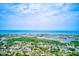 Breathtaking aerial view of waterfront homes, a serene bay, and the endless expanse of the ocean at 14130 Rosemary Ln # 4115, Largo, FL 33774