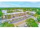 Aerial view of the community featuring buildings, parking, landscaping, and pond at 14130 Rosemary Ln # 4115, Largo, FL 33774