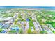 Stunning aerial view showcasing the neighborhood, community pool, and surrounding lush landscaping at 14130 Rosemary Ln # 4115, Largo, FL 33774