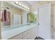Bathroom featuring a long vanity and decorative wallpaper at 14130 Rosemary Ln # 4115, Largo, FL 33774