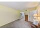 Bright bedroom with carpet and a view of the bathroom at 14130 Rosemary Ln # 4115, Largo, FL 33774