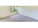 Bright and carpeted bedroom with a large window at 14130 Rosemary Ln # 4115, Largo, FL 33774