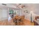 Dining area showing wood table and chairs, views to the living room, and a ceiling fan at 14130 Rosemary Ln # 4115, Largo, FL 33774