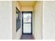Front entrance featuring a well-lit doorway with a screen door at 14130 Rosemary Ln # 4115, Largo, FL 33774