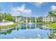 Scenic view of condo buildings overlooking a tranquil lake with a fountain feature at 14130 Rosemary Ln # 4115, Largo, FL 33774