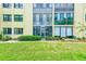 Exterior elevation showing manicured lawn and building with neutral color and lots of windows at 14130 Rosemary Ln # 4115, Largo, FL 33774